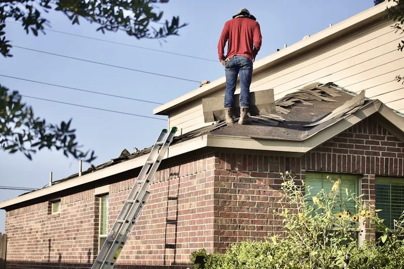 Professional roofer working on a residential roof in Fairland